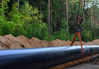 Natural gas pipeline construction work. A dug trench in the ground for the installation and...