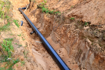 Excavated trench to install gas supply pipework for the power station. Sections of pipe on top of...