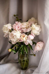 a bouquet of pink peach beige white delicate peonies