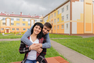 Fototapeta premium Happy man hugs a woman in the street