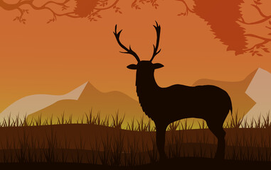 Silhouette of a deer on a background of mountains.