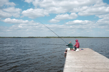 Senior couple fishing on the pier of lake