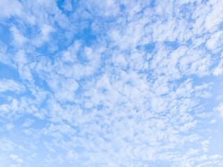Fototapeta na wymiar Fluffy white clouds in the bright blue sky