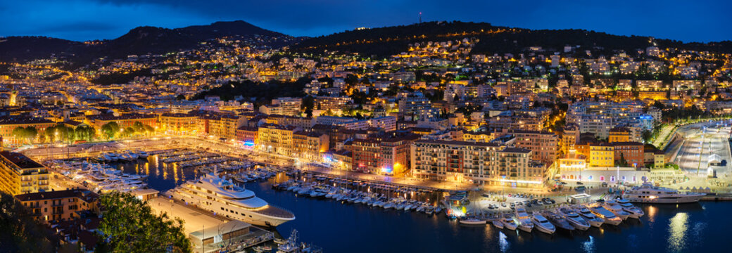 Panorama of Old Port of Nice with luxury yacht boats from Castle Hill, France, Villefranche-sur-Mer, Nice, Cote d'Azur, French Riviera in the evening blue hour twilight illuminated