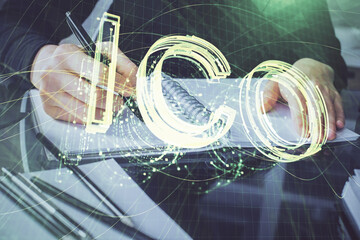 Cryptocurrency hologram over woman's hands writing background. Concept of blockchain. Multi exposure