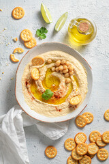 Delicious hummus with crackersi, coriander and lime
