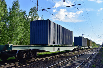 Cargo Containers Transportation On Freight Train By Railway. Intermodal Container On Train Car....