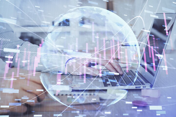 Multi exposure of stock market graph with man working on laptop on background. Concept of financial analysis.