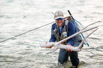 Close up of a smiled fly fisherman posing with his catch