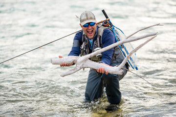 Close up of a smiled fly fisherman posing with his catch