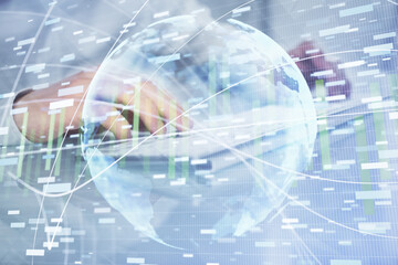 Double exposure of businessman working on laptop on background. International business hologram in front. Concept of success.