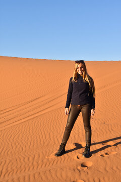Beautiful woman walking on the desert