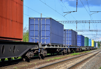 Cargo Containers Transportation On Freight Train By Railway. Intermodal Container On Train Car....
