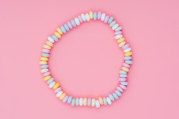 sweets Beads and bracelets candy on a pink background