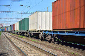 Cargo Containers Transportation On Freight Train By Railway. Intermodal Container On Train Car....