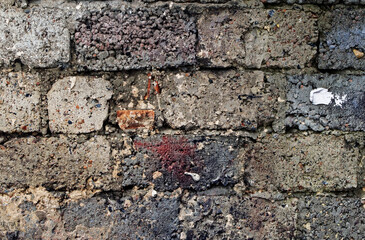 Texture old ragged brickwork in the mud