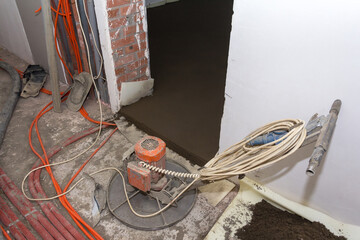 The process of filling floors in a new house. Concrete floors in a new building. Equipment for filling the floor. Concrete filling process.