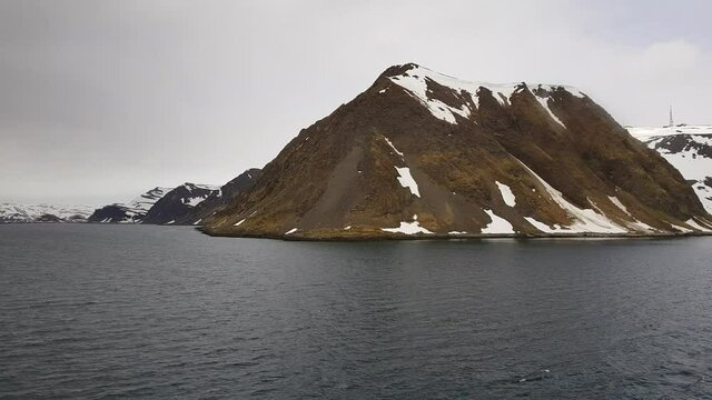 mighty sea and snowy mountain view sailing a ship in Finnmark, northern Norway