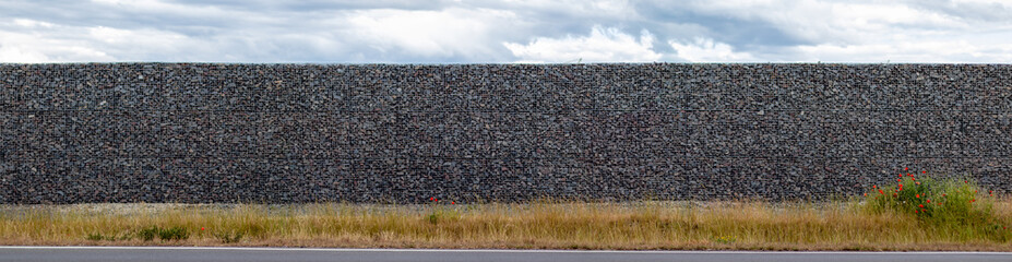 gabion wall made of metal grid filled with gravel