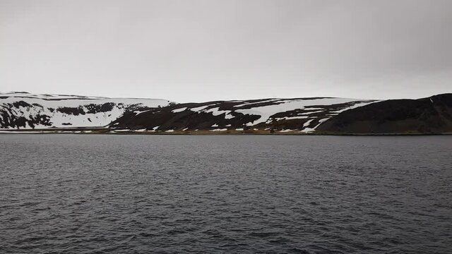mighty sea and snowy mountain view sailing a ship in Finnmark, northern Norway