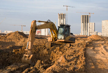Excavator working at construction site. Backhoe during road works. Digging ground for the...
