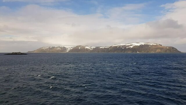 mighty sea and snowy mountain view sailing a ship in Finnmark, northern Norway
