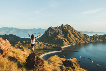 Woman with amazing view of Padar island in Komodo national park, Indonesia. Enjoying tropical...