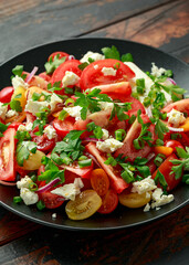 Tomato salad with feta cheese, spring onion and parsley. Healthy summer food