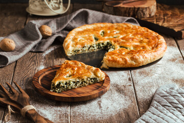 Fresh baked pie with spinach and cheese filling 