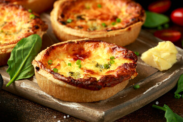 Cheddar cheese and spring onion omelette tarts served on wooden board with side salad. Healthy breakfast food
