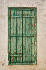Green weathered wooden window in a village building Cyprus
