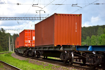 Fototapeta na wymiar Cargo Containers Transportation On Freight Train By Railway. Intermodal Container On Train Car. Rail Freight Shipping Logistics Concept. Import - export goods from Сhina. Global economy in recession