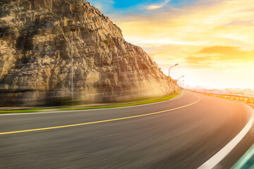 Motion blurred road and mountains at sunrise.mountain road background.