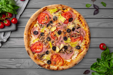 Tasty hot italian pizza with ham, mushrooms, artichokes, olives. Pizzeria menu. Concept poster for Restaurants or pizzerias. Top view