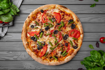Tasty hot italian vegetarian pizza with green beans, olives, tomatoes and cheese. Pizzeria menu. Concept poster for Restaurants or pizzerias. Top view