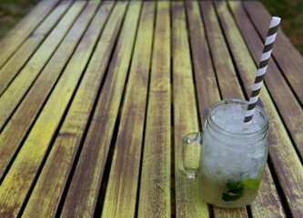 delicious mojito prepared on old wooden table