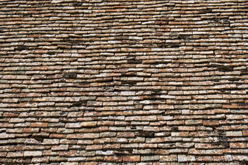 Texture of terracota tiles. Old weathered tile roof background