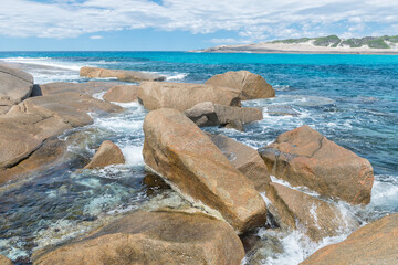 Stone boulders in the foamy waves of the azure ocean, Salmon Beach, Esperance, Western Australia