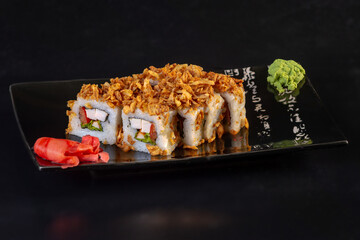 rice rolls on a black plate on a dark background asian menu