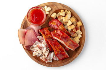 Smoked pork ribs in the glaze, lard, crackers with garlic. Snack for beer or vodka. Banquet festive dishes on white
