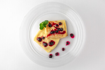 Topped pancakes. Banquet festive dishes. Gourmet restaurant menu. White background.
