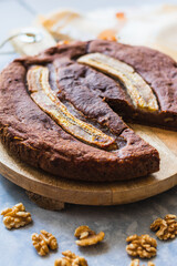 View of a homemade round banana bread with bananas and walnuts
