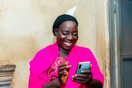 Cheerful Excited Old Black African Woman Receiving Some Good News With Her Smart Phone.happy Senior Lady Using Mobile Phone