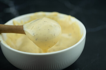 Use wooden spoon scoop of caesar salad dressing