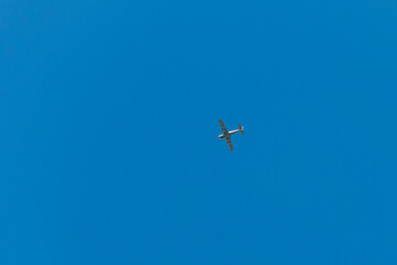 Biplane flying in blue sky