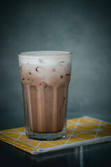 Ice coffee with milk cream in a tall glass.