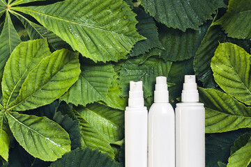 Unbranded skincare products white plastic bottle with dispenser and flacons. Tube for cream...