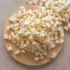 Popcorn on wooden tray. Food background. Top view.