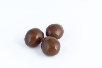 Almonds in chocolate glaze on a white background