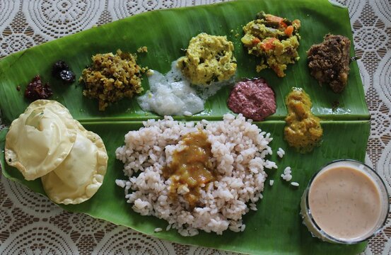 Kerala sadya traditional south Indian cuisine served on banana leaf with rice sambar avial payasam and other vegetarian dishes